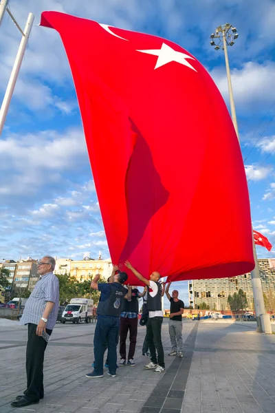 Turkish people gathering and waving flags at Taksim Square. The meetings were called Duty for Democracy after the failed July-15 coup attempt of Gulenist militants.