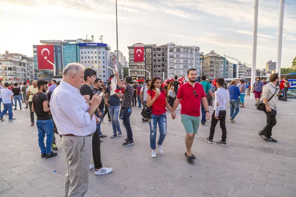 Turkish people gathering and waving flags at Taksim Square. The meetings were called Duty for Democracy after the failed July-15 coup attempt of Gulenist militants.