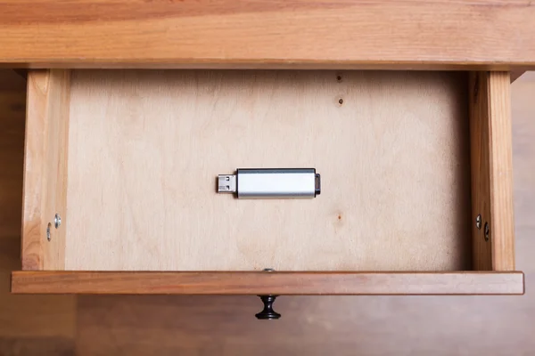 One flash drive in open drawer