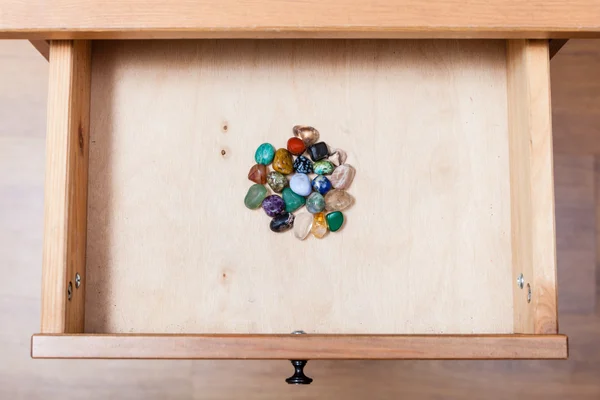 Pile of gem stones in open drawer
