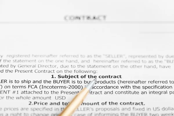 Golden pen on sheet of sales contract