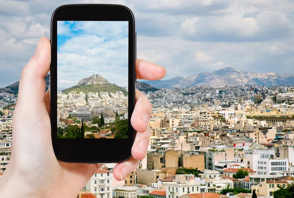 Tourist taking photo of Athens city skyline