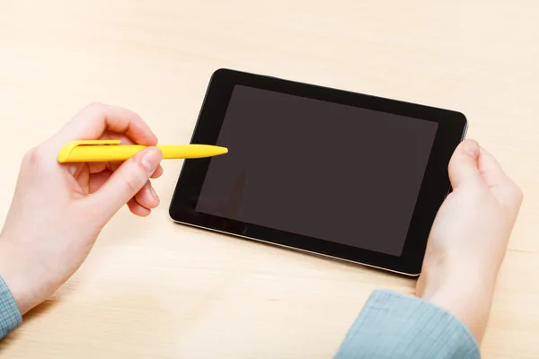 Man touches by pen of tablet PC with black screen