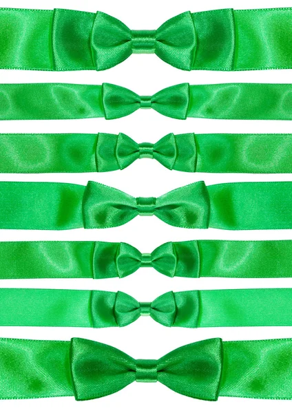 Set of symmetric bow knots on green satin ribbons