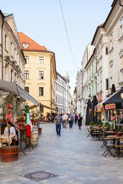 Tourists walk on Venturska street in Bratislava