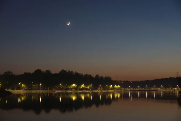 Moon over the lake in the evening