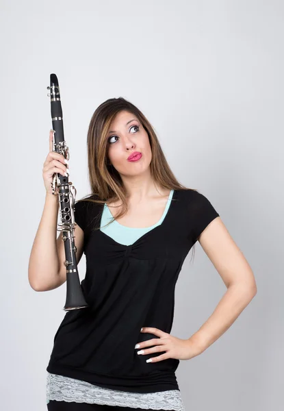Woman perplexed with clarinet