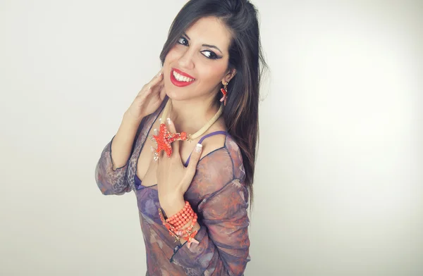 Woman smiling with perfect smile wearing jewelry