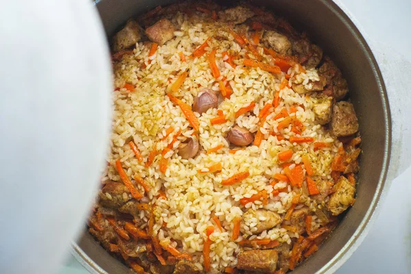 Pilaf with meat and vegetables above