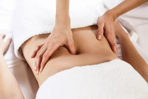 Woman having abdomen massage.