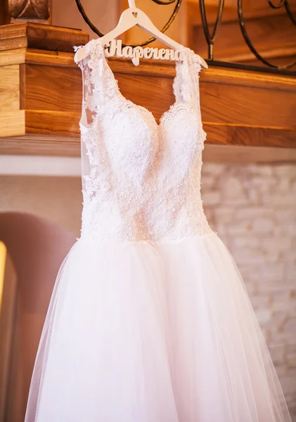 The perfect wedding dress with a full skirt on a hanger in the r