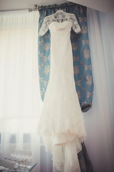 The perfect wedding dress with a full skirt on a hanger in the r