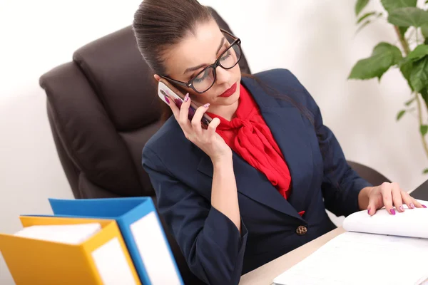 Young and attractive business woman working in office