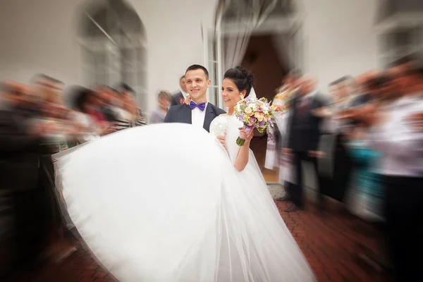 Handsome brunette groom kissing beautiful bride in wedding dress