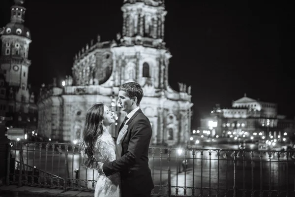 Gorgeous wedding couple background night city with castle in light