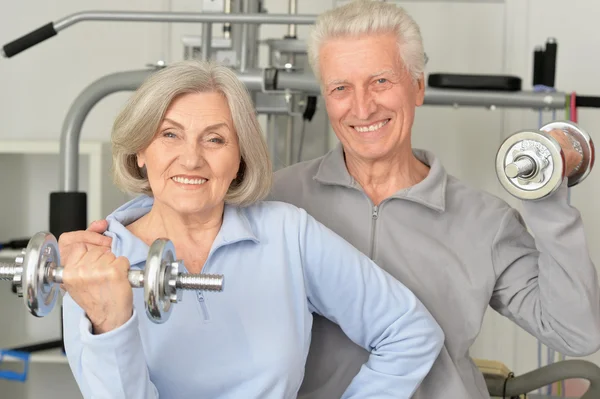 Senior couple exercising in gym