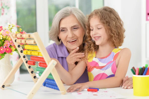 Girl making homework with granny