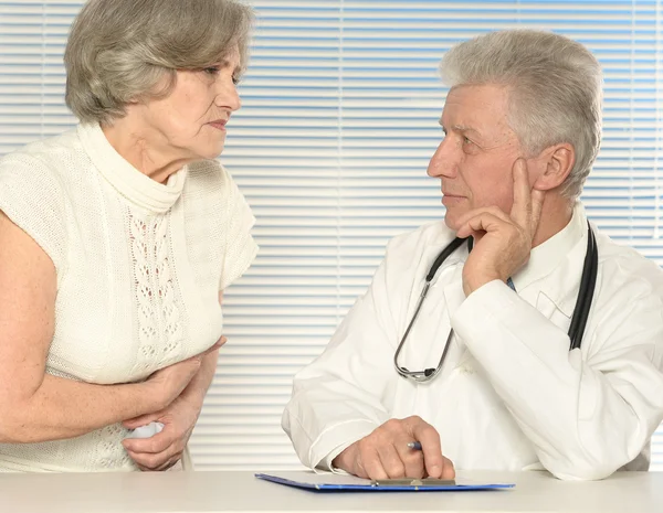 Caucasian nice old doctor with a patient