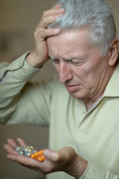 Older man taking a medicine