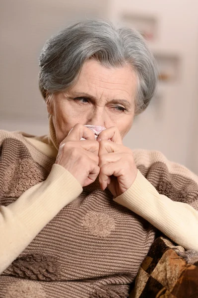 Ill elderly woman with handkerchief