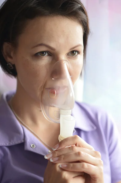 Young woman doing inhalation