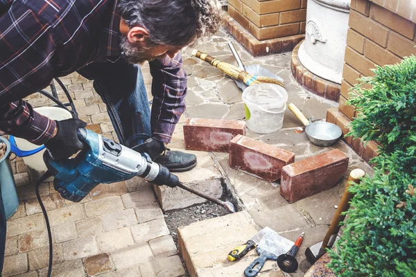 Man working in yard puncher