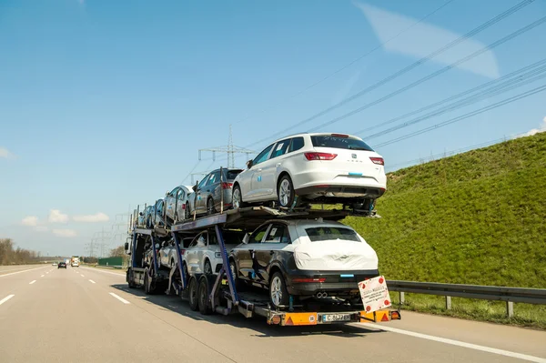 German autobahn with traile transporting cars