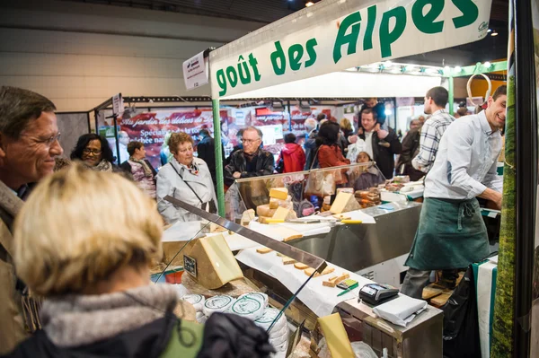 People buying cheese and other French cheese products at market