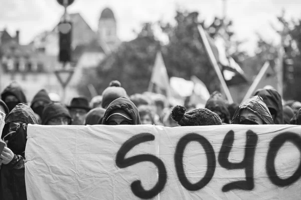 Grouop with covered face during protest