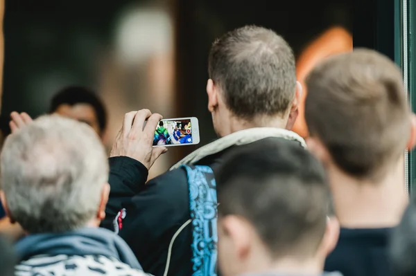 Man photographing on his smarthone the Apple Store entrance