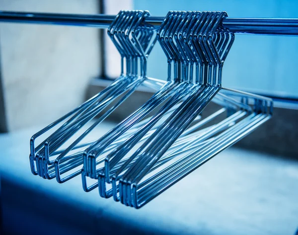 Metallic coat hangers on clothes rail
