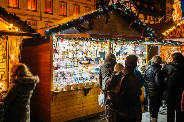 Christmas Market with people admiring gifts at kiosk