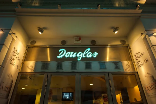 Douglas beauty and fragrance store at night.