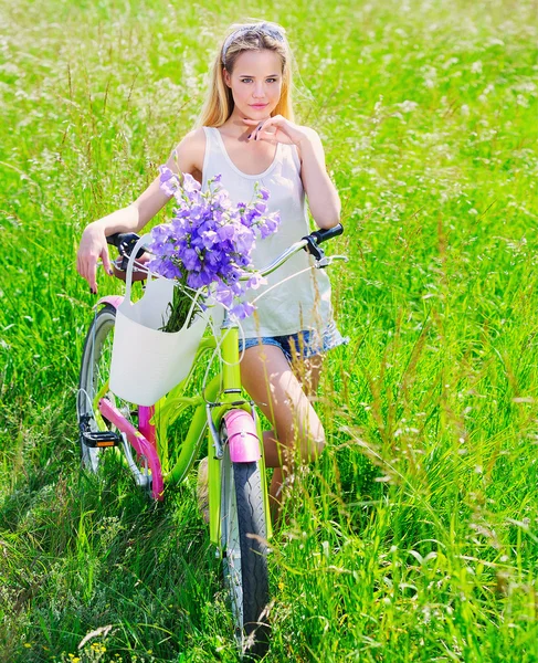 Beautiful young girl with her cruiser bike