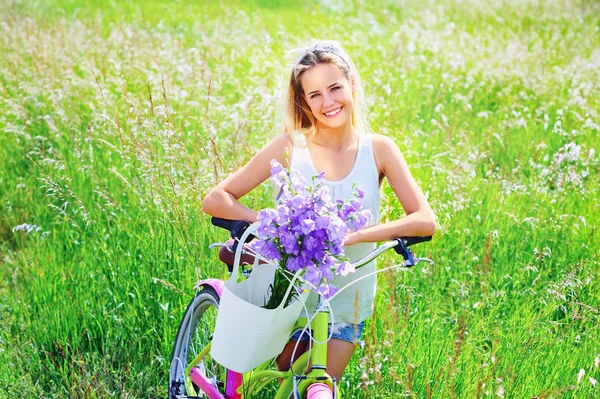 Beautiful young girl with her cruiser bike