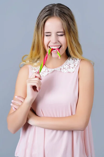 Beautiful woman having fun with bright candy