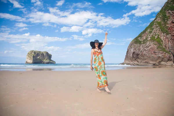 Happy woman vintage dress dancing at beach