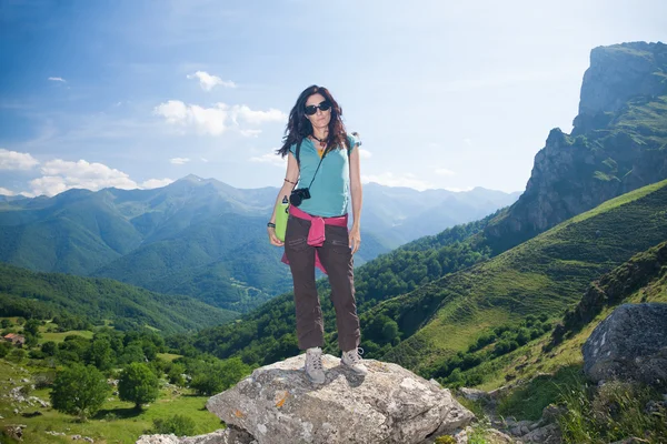 Woman posing on rock in Cantabrian mountain