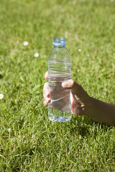 Open water plastic bottle in hand
