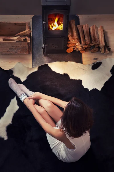 Woman sitting down on a cow rug