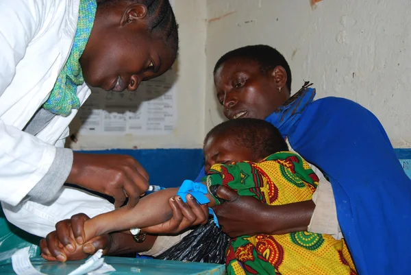 An unidentified child is subjected to HIV tests in the dispensar