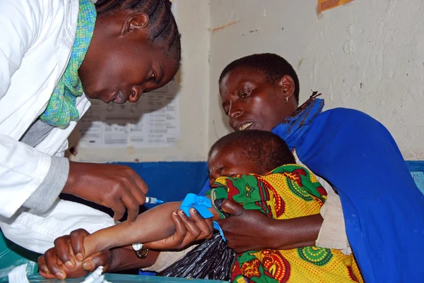 An unidentified child is subjected to HIV tests in the dispensar