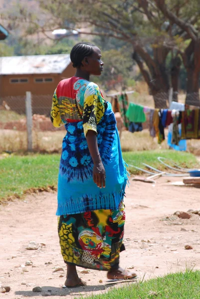 A pregnant African woman walks in the courtyard of the Ipamba Ho