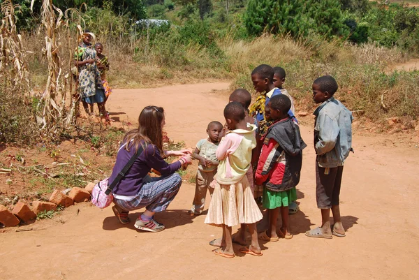 A volunteer female doctor speaks with African children 62