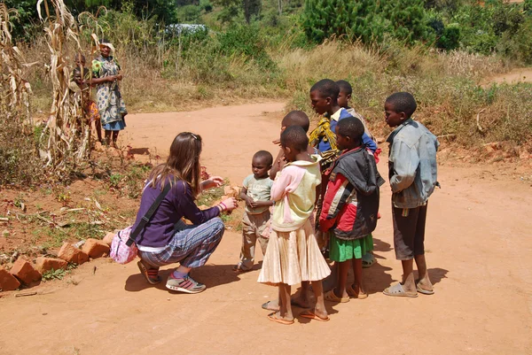 A volunteer female doctor speaks with African children 61