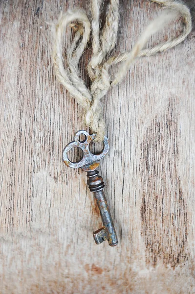 Vintage key on wooden background