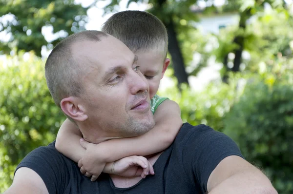 Child hugging his father