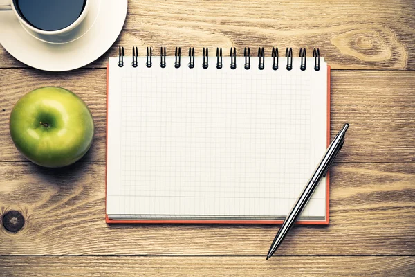 Notepad with  coffee , green apple and pen