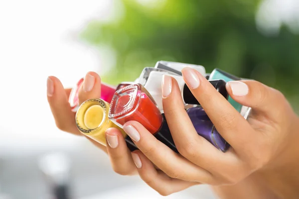 Woman hands with nail polishes