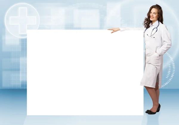 Young woman doctor standing near a blank banner